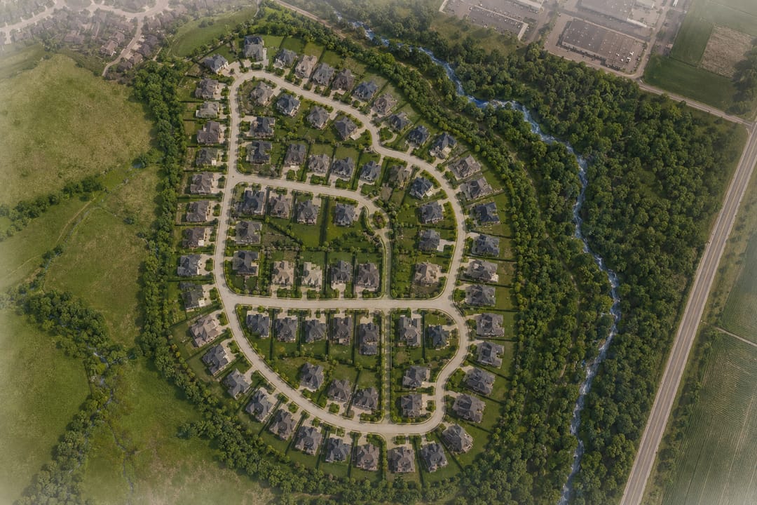 Annotated aerial site plan — 59 exclusive estate homes bounded by the natural creek, preserved woodland and Heritage Road